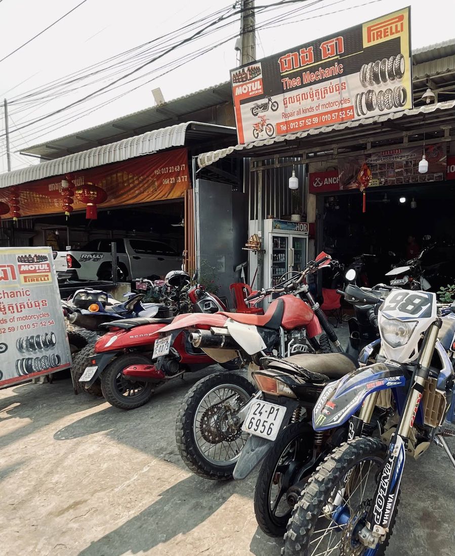 Thea Mechanic shopfront on Sok San Road with its sign and motorcycles parked outside